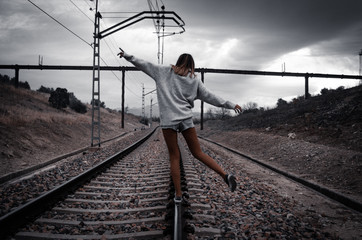 Girl balancing on the train tracks