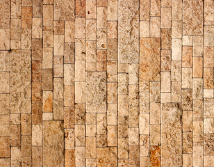 Texture of stone wall, square yellow travertine tile.