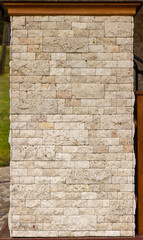 Texture of stone wall, square yellow travertine tile.