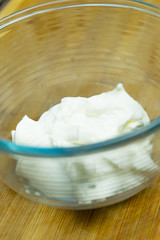Natural sour cream in a glass plate.