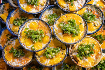 The quail eggs grilled in porcelain bowls at night market in Phu Quoc