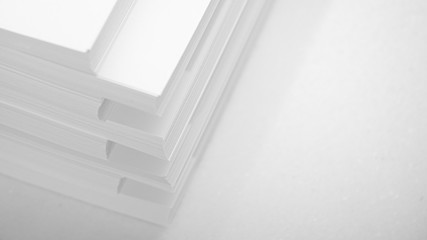 Obraz premium Several stacks of white paper on a white background