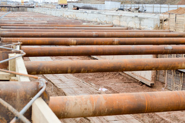 A large huge ditch pit tunnel with reinforcing structures from thick iron pipes of beams and...