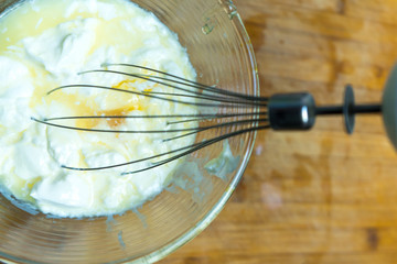 Mixing ingredients to prepare a complex dish.