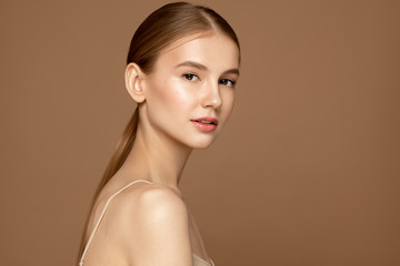 Face skin care. Beautiful young woman with perfect skin posing against background. Beauty treatment...
