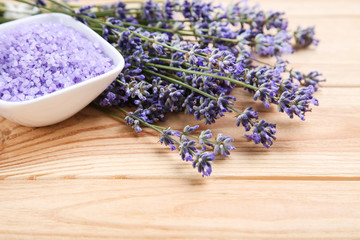 Obraz na płótnie Canvas Lavender flowers and spa salt on brown wooden table