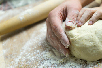 Manual kneading of dough for cooking homemade food.