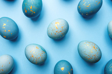 Easter background of eggs painted in blue color. Flat lay, top view.