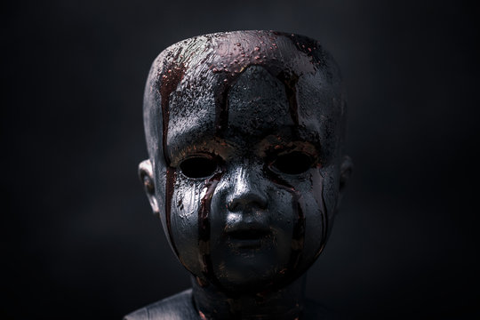 Creepy bloody doll in the dark