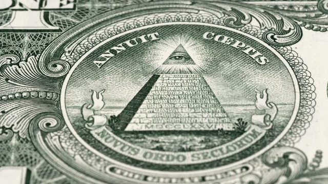 Great seal on 1 US dollar bill tracking, pyramid and Eye of Providence. Slider shot. Low angle, macro. 4K