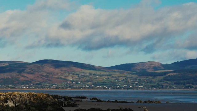 Time lapse of distant hills, passing clouds and sea coast in County Louth on the East coast of Ireland. Ravensdale hills near Dundalk.