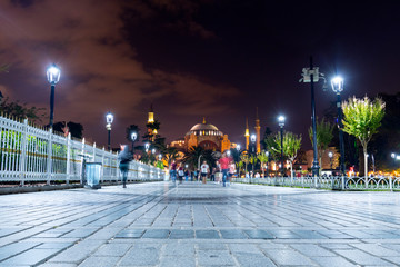 The ancient Hagia Sophia, once a cathedral and an Ottoman mosque and now a museum, illuminated at night in Sultanahmet Square in Istanbul Turkey.