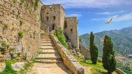 Fototapeta na wymiar Summer mediterranean landscape - view of the stairs in the Klis Fortress, near Split on the Adriatic coast of Croatia
