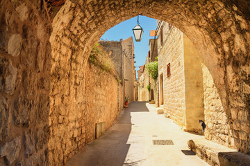 Fototapeta premium Mediterranean summer cityscape - view of a medieval street in the Old Town of Hvar, on the island of Hvar, the Adriatic coast of Croatia