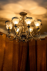 vintage chandelier and eight lampshades on it against