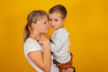 Little boy with mom on a yellow background