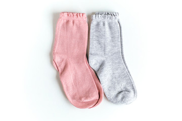 isolated pink and gray baby socks on a white background