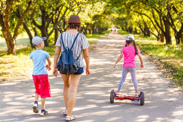 Fototapeta premium mother and two children on natural background