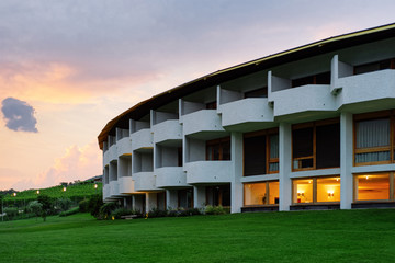 Fototapeta na wymiar Sunset at Modern luxury hotel or villa building architecture and landscape evening