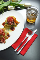 Exquisite culinary dishes and desserts on the black table. Restaurant serving.