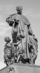 TURIN, ITALY - MARCH 15, 2017: The statue of Don Bosco the founder of Salesians in front of Basilica Maria Ausilatrice (Basilica of Mary Help) by  Gaetano Cellini (1914).