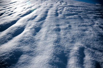 snow surface in the night with waves in winter