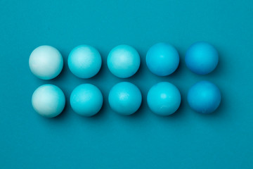 Ten easter eggs in blue gradient color design on a blue background