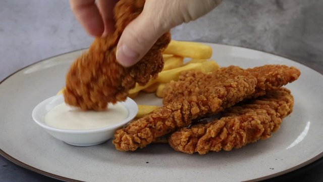 Dipping Chicken Strips into Ranch Dressing