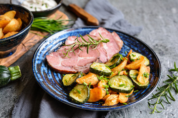 Smoked pork neck with crispy roasted potatoes and zucchini slices