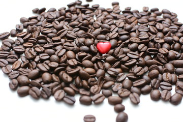  Processed coffee beans and tostao, with red heart on wooden background