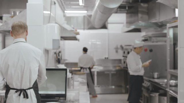 Picture of modern restaurant kitchen with working employees