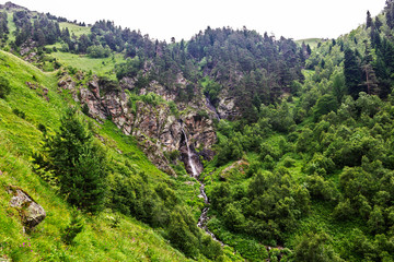 waterfall flowing down a steep cliff in the mountains