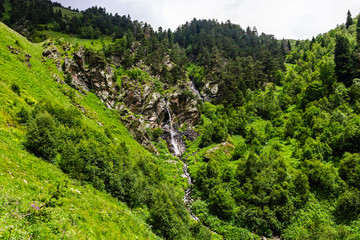 waterfall flowing down a steep cliff in the mountains