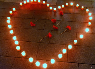 Brennende Kerzen in Herzform auf einer Mahnwache für die Opfer von Hanau