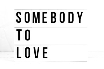 Somebody To Love flat lay on a white background. Love and relationship Retro board