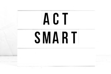 Act Smart flat lay on a wooden white background. Motivational business start up board. Retro
