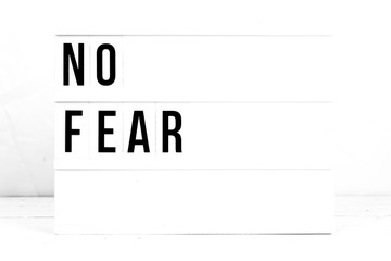 Motivational No Fear quote on vintage retro board. Concept. flat lay
