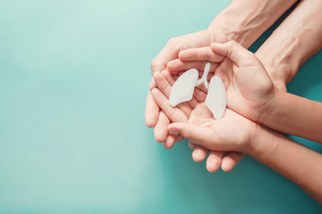 Adult and child hands holding lung, world tuberculosis tb day, world no tobacco day, lung cancer, long covid, COPD,  eco air pollution, organ donation concept