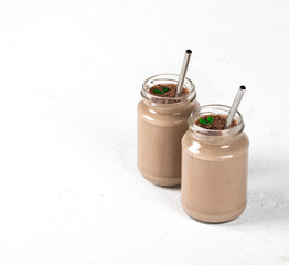 Milk chocolate cocktail with ice cream in a jar on a light background