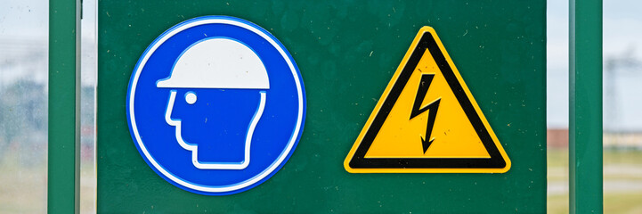 Sign on fence high voltage, attention danger. Panoramic image