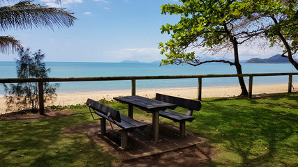 Fototapeta na wymiar Bench next to the beach with ocean view