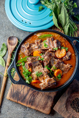 Beef ribs Bourguignon. Beef ribs stewed with carrot, onion in red wine. France dish. Top view