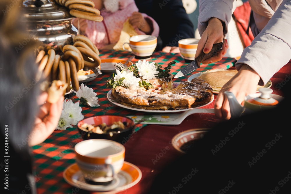 Wall mural spring picnic. winter tea party in nature. pie with berries