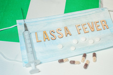Nigerian flag under words Lassa fever outbreak concept. protective breathing mask and syringe. Lassa hemorrhagic fever LHF endemic in West Africa including Sierra Leone, Liberia, Guinea and Nigeria