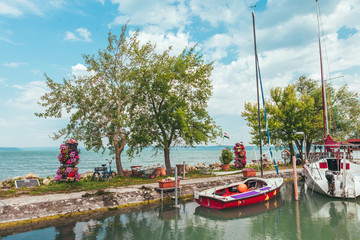 View to entrance to Siofok harbor at Balaton lake, Hungary, with crystal clear water of emerald...