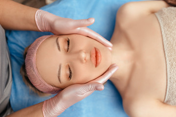 Obraz na płótnie Canvas face massage on woman in the spa salon