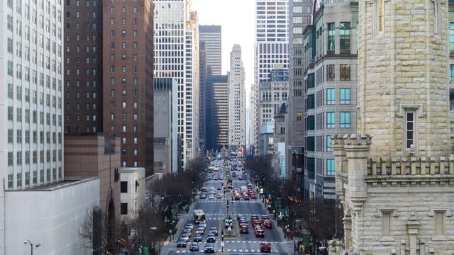 4K UHD Time lapse : Car on road and traffic at north Michigan avenue road in Chicago city downtown, USA. Aerial top view zoom. fly upward. Commuter, America city life or public transportation concept