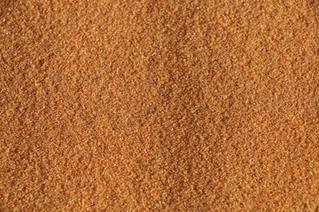 sand texture - background of desert sand dunes. Beautiful structures of sandy dunes. sand with wave from wind in desert - Close up