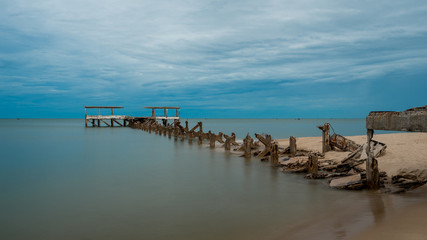 Dilapidated old fishing dock collapsing into the sea in Pak Nam Pran Thailand