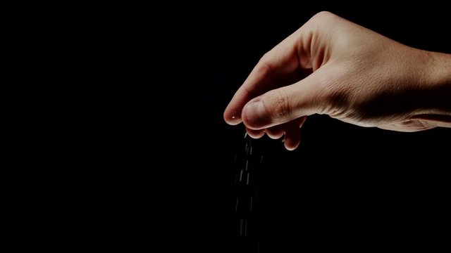 Male chef sprinkles salt and pepper, slow motion